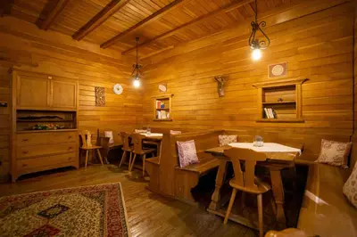 a dining room with wooden walls and tables and chairs at Hotel Salegg in Siusi