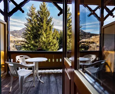 a balcony with a table and chairs and a view at Hotel Salegg in Siusi