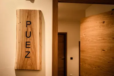 a bedroom with a bed with two lamps on it at Luxury Chalet Plazola in Selva di Val Gardena