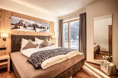 a living room with a table and a couch at Luxury Chalet Plazola in Selva di Val Gardena