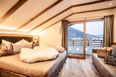 a kitchen and dining room with a table and chairs at Luxury Chalet Plazola in Selva di Val Gardena