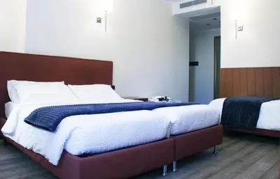 a bedroom with two beds with white and blue blankets at Antica Trattoria in Cles