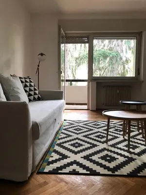 a living room with a couch and a table at Residenza XXX Aprile in Merano