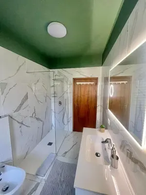a bathroom with a sink and a shower and a tub at Residenza XXX Aprile in Merano