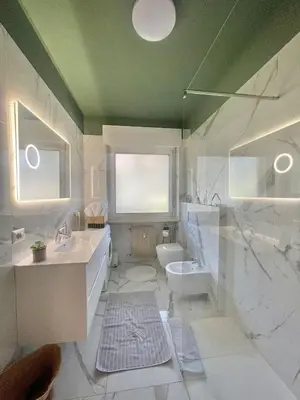 a white bathroom with a sink and a toilet at Residenza XXX Aprile in Merano
