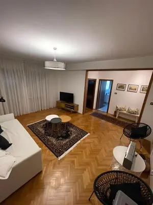 a living room with a white couch and a table at Residenza XXX Aprile in Merano