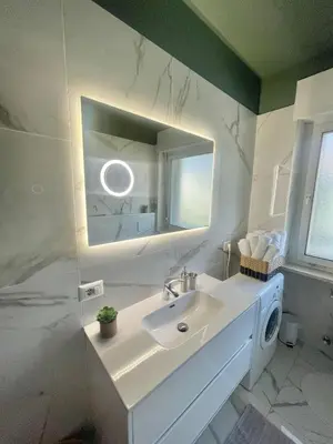 a bathroom with a sink and a mirror at Residenza XXX Aprile in Merano