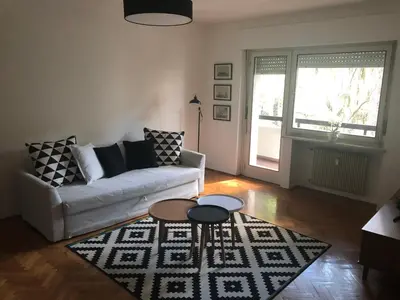a living room with a couch and a table at Residenza XXX Aprile in Merano