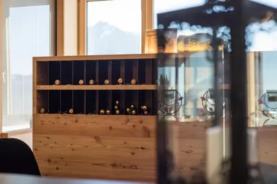 a cabinet filled with lots of wine bottles at Berghotel Schlemmer in Bressanone