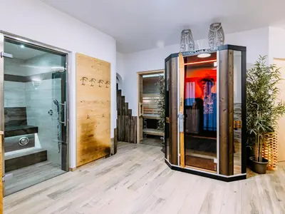 a room with wooden floors and a large glass door at Apartment Spieglhof-2 by Interhome in Sarntal