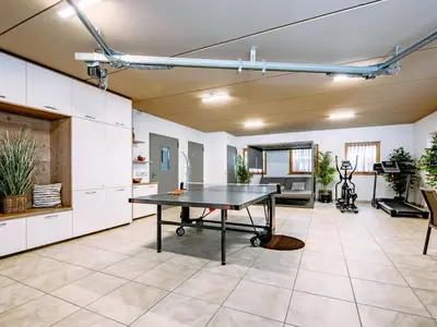 a living room with chairs and a stone wall at Apartment Spieglhof-2 by Interhome in Sarntal