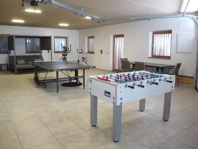 a ping pong table in a room with a ping pong ball at Apartment Spieglhof-1 by Interhome in Sarntal