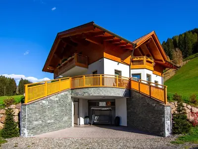 a bedroom with a bed with pillows and a window at Apartment Spieglhof-1 by Interhome in Sarntal