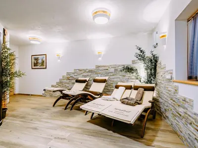 a room with chairs and a stone wall at Apartment Spieglhof-3 by Interhome in Sarntal