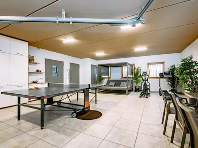 an empty room with a ping pong table in it at Apartment Spieglhof-3 by Interhome in Sarntal