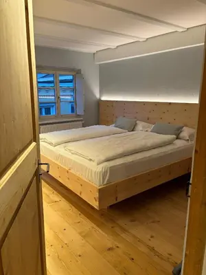 a bedroom with a large bed in a room at ADAM Suites - Brixen Card included in Bressanone