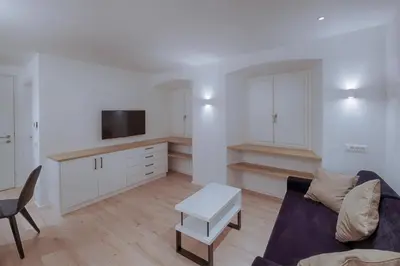 a living room with a couch and a table at ADAM Suites - Brixen Card included in Bressanone