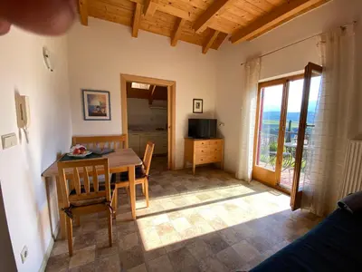 a kitchen and dining room with a table and chairs at Gästehaus Anna in Caldaro