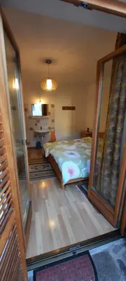 a bedroom with a bed and a large glass window at Hof am Brunnen in Cornaiano