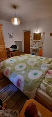a bedroom with a large bed with a colorful bedspread at Hof am Brunnen in Cornaiano