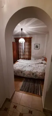 a bedroom with a bed and an arched doorway at Hof am Brunnen in Cornaiano