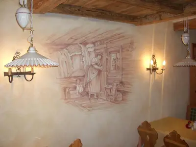 a drawing on the wall of a dining room at Hotel Garni San Nicolò in Pozza di Fassa