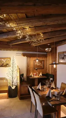 a dining room with a table and chairs at Hotel Garni San Nicolò in Pozza di Fassa