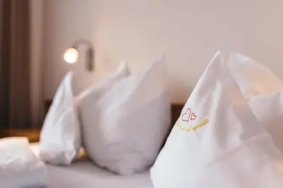 a close up of white pillows on a bed at Apartment Ruprecht in Tirolo