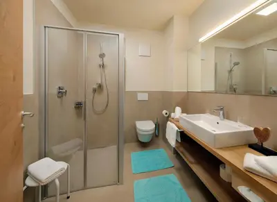 a bathroom with a shower and a sink and a toilet at Apartment Ruprecht in Tirolo