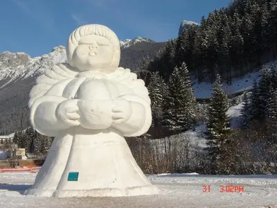 a large white statue in front of a mountain at Hotel Stella Alpina in Moena