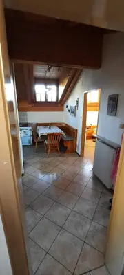 a view of a room with a table in a room at Hof am Brunnen Mansarde in Cornaiano