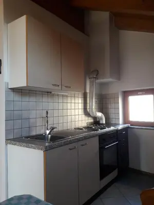 a kitchen with a sink and a counter top at Hof am Brunnen Mansarde in Cornaiano