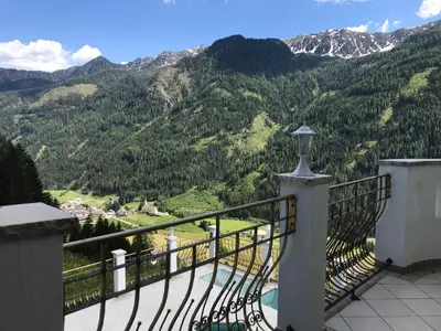 a balcony with a view of a mountain at Das Land-Palais - Your lovely Mountain Hideaway in Selva dei Molini