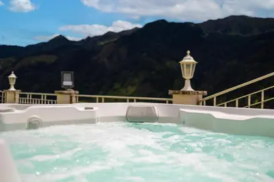 a jacuzzi tub with a view of the mountains at Das Land-Palais - Your lovely Mountain Hideaway in Selva dei Molini