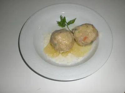 two meatballs on a white plate on a table at Hotel Villa Ines in Borca di Cadore