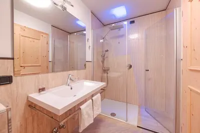 a bathroom with a sink and a shower at Hotel Foresta in Moena