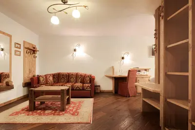 a living room with a couch and a table at Hotel Foresta in Moena