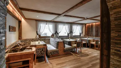 a restaurant with tables and chairs in a room at Hotel Brunella in San Vigilio Di Marebbe