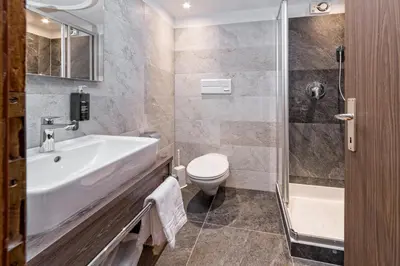 a bathroom with a shower and a sink at Hotel Brunella in San Vigilio Di Marebbe