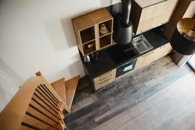 an overhead view of a kitchen with wooden cabinets at Antonya Apartments in Schenna
