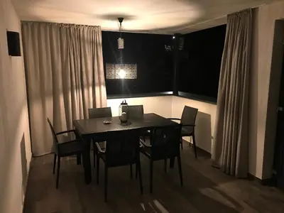 a dining room table and chairs in a room at Antonya Apartments in Schenna