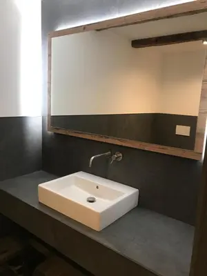 a bathroom with a white sink and a mirror at Antonya Apartments in Schenna
