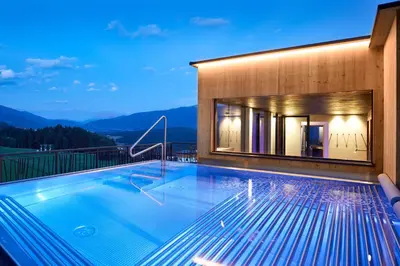 a swimming pool on the roof of a house at Naturhotel Die Waldruhe GmbH in Chienes