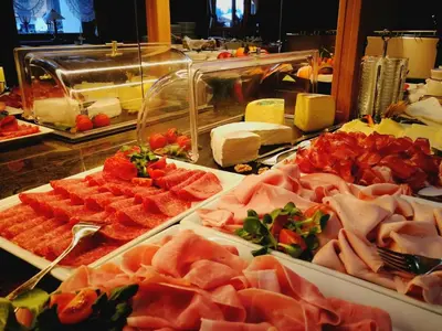 a buffet with many different types of meats and cheese at Wellness Hotel Gran Risa***S in La Villa