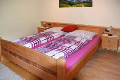 a bedroom with a wooden bed with a wooden frame at Ferienwohnung Leachwies in Schenna