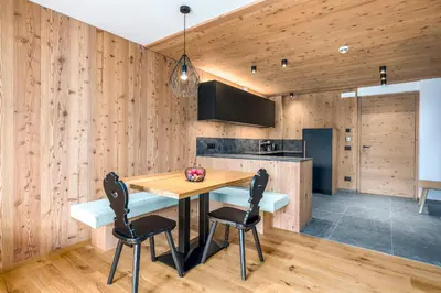 a kitchen and dining room with a table and chairs at SUMMERER - Living Nature - Apartments with private SPA in Bressanone