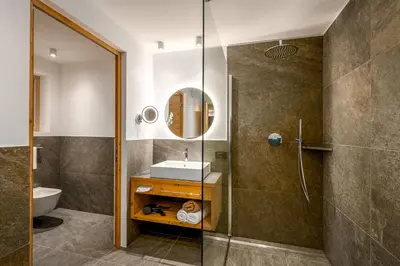 a bathroom with a sink and a shower at SUMMERER - Living Nature - Apartments with private SPA in Bressanone
