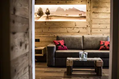a living room with a couch and a table at Apartments Grunnes in Ortisei