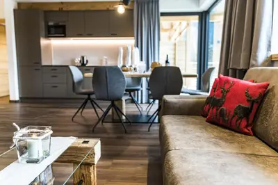 a living room with a couch and a table at Apartments Grunnes in Ortisei