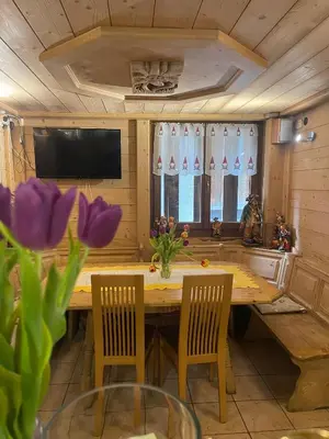 a bed with a wooden headboard in a room at Chalet Valeruz in Canazei